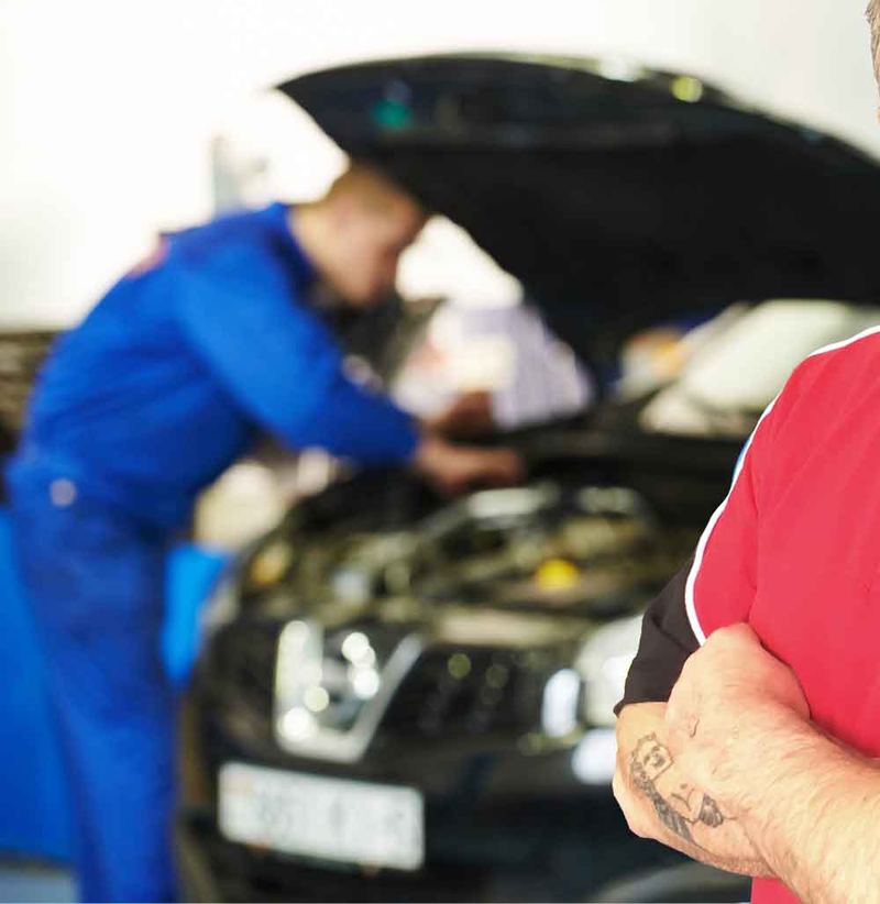 Mechanic diagnosing a fault under the bonnet